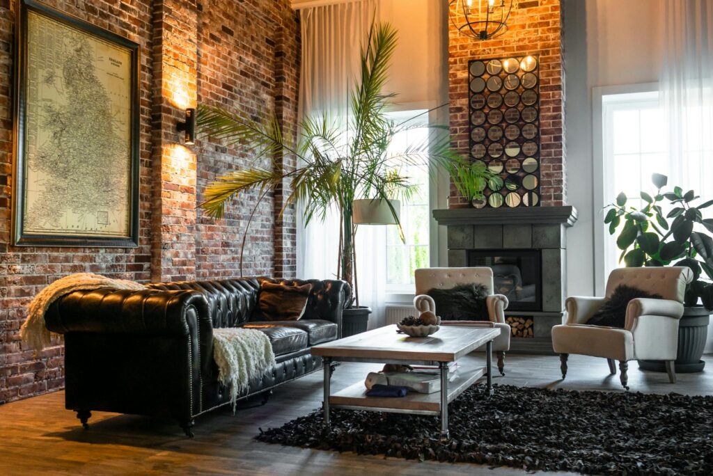 Cozy living room with industrial design featuring brick walls, classic furniture, and chic decor.